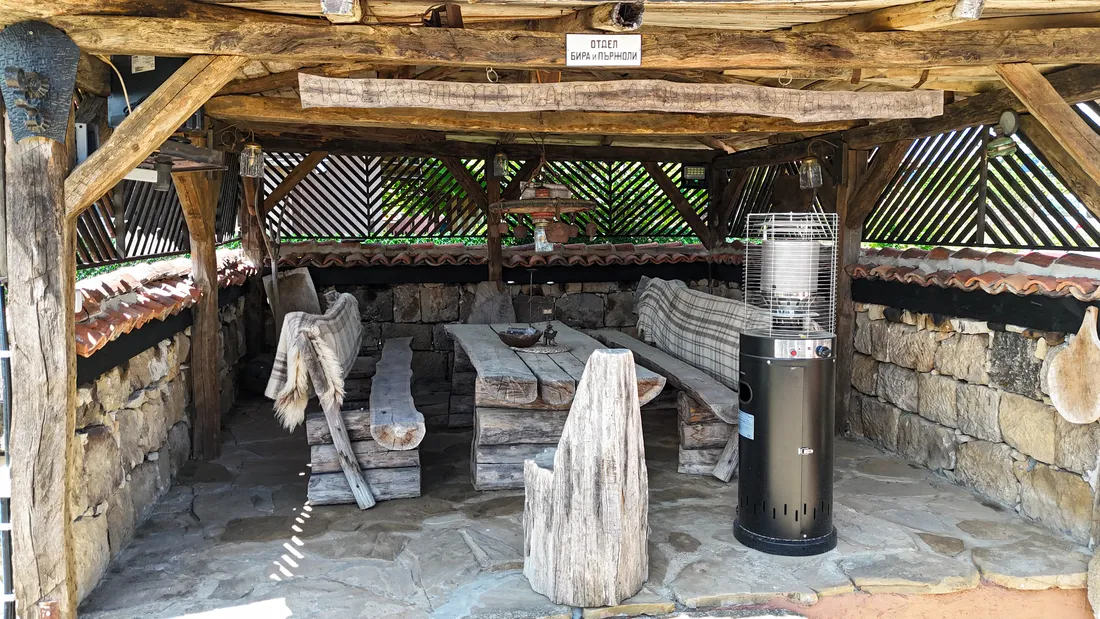 The covered gazebo with its wood-fired barbecue and long table